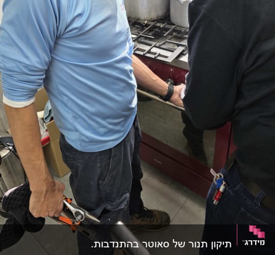 שני אנשים עובדים ליד כיריים עם כלים